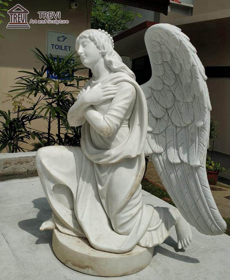 marble jesus and angel sculpture